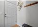 Welcoming entryway with a white door, decorative mirror, and a coat rack at 401 Oak Hollow Ct, Raleigh, NC 27613