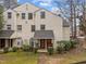 Inviting two-story townhouse with well-maintained landscaping, parking, and a cozy entrance at 401 Oak Hollow Ct, Raleigh, NC 27613