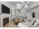 Open living room with vaulted ceilings, fireplace, staircase, and hardwood floors at 401 Oak Hollow Ct, Raleigh, NC 27613