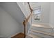 Well-lit staircase with wooden handrail and white risers, leading to the upper level at 401 Oak Hollow Ct, Raleigh, NC 27613