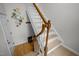 Elegant staircase with wooden handrail and white spindles, complemented by stylish wall decor at 401 Oak Hollow Ct, Raleigh, NC 27613