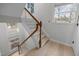 Traditional staircase with wood handrail and white balusters, lit by natural light at 401 Oak Hollow Ct, Raleigh, NC 27613
