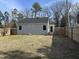 View of the backyard with a wooden privacy fence and large trees beyond the property line at 4319 Denfield St, Durham, NC 27704