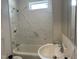 Updated bathroom with white tiled shower and tub and modern sink at 4319 Denfield St, Durham, NC 27704