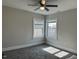 Bedroom with grey walls, carpeting, a ceiling fan, and windows for natural light at 4319 Denfield St, Durham, NC 27704