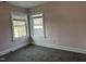 Bedroom featuring plush carpeting, pink painted walls, and windows for natural light at 4319 Denfield St, Durham, NC 27704