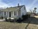 Charming home with a covered front porch and light gray siding; a freshly planted flower bed is visible at 4319 Denfield St, Durham, NC 27704
