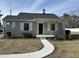 Charming home with a curved walkway, light gray siding, and a covered front porch at 4319 Denfield St, Durham, NC 27704