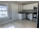 Corner kitchen featuring stainless steel appliances, granite countertops, and bright, natural light at 4319 Denfield St, Durham, NC 27704