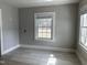 Comfortable living area with grey walls, white trim, and multiple windows for natural light at 4319 Denfield St, Durham, NC 27704