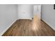 Unfurnished bedroom featuring wood flooring, white walls, white trim, and a closet with double doors at 475 Bramble Ln, Clayton, NC 27527