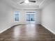 Spacious bedroom with hardwood floors, tray ceilings, and natural light from the sliding glass doors at 475 Bramble Ln, Clayton, NC 27527