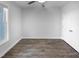 Unfurnished bedroom with neutral walls, wood flooring, a ceiling fan, and a double-door closet at 475 Bramble Ln, Clayton, NC 27527