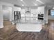 Modern kitchen with white cabinets, stainless steel appliances, a large island, and granite countertops at 475 Bramble Ln, Clayton, NC 27527