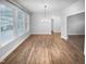 This living room boasts many windows, wood flooring, and a modern light fixture at 475 Bramble Ln, Clayton, NC 27527