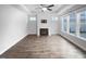 Bright living room with a fireplace, ceiling fan, and large windows offering plenty of natural light at 475 Bramble Ln, Clayton, NC 27527