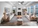Bright, modern living room featuring hardwood floors, a fireplace, and a neutral color palette at 475 Bramble Ln, Clayton, NC 27527