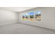 Bedroom featuring plush carpeting and a row of windows showcasing views of a construction site and distant houses at 521 Old Battle Bridge Rd, Wendell, NC 27591