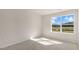 Bright bedroom featuring neutral walls, plush carpet, and a large window with a view at 521 Old Battle Bridge Rd, Wendell, NC 27591