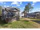 Landscaped backyard featuring a deck, outdoor bar area, and additional parking alongside lush green grass at 5904 River Lake Cir, Raleigh, NC 27604