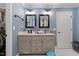 Light blue bathroom featuring double sink vanity with black hardware and square framed mirrors at 5904 River Lake Cir, Raleigh, NC 27604
