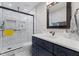 Bright bathroom showcasing a modern glass shower with subway tile and navy vanity at 5904 River Lake Cir, Raleigh, NC 27604