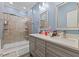 Full view of the updated bathroom featuring a shower and a double sink vanity at 5904 River Lake Cir, Raleigh, NC 27604