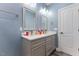 Bathroom featuring double vanity with modern fixtures, framed mirrors, and gray cabinetry at 5904 River Lake Cir, Raleigh, NC 27604