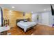 Bedroom with hardwood floors, a wood accent wall, and two closets at 5904 River Lake Cir, Raleigh, NC 27604