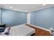 Spacious bedroom features hardwood floors, fresh paint, and a comfortable queen bed at 5904 River Lake Cir, Raleigh, NC 27604