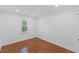 Bright bedroom with hardwood floors, a window view, and neutral-colored walls at 5904 River Lake Cir, Raleigh, NC 27604