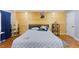 Bedroom with hardwood floors and a wood accent wall, with ample natural light at 5904 River Lake Cir, Raleigh, NC 27604