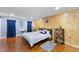 Bedroom with hardwood floors and a wood accent wall, with ample natural light at 5904 River Lake Cir, Raleigh, NC 27604