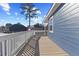 A spacious deck with white railings overlooks the neighborhood and complements the blue siding of the house at 5904 River Lake Cir, Raleigh, NC 27604