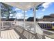 A sun-drenched deck with white railings offers scenic views of the backyard and surrounding neighborhood at 5904 River Lake Cir, Raleigh, NC 27604