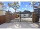 Metal driveway gate with stone pillars with a concrete driveway leading to the house at 5904 River Lake Cir, Raleigh, NC 27604