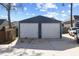 Two-car detached garage with white doors provides convenient parking and storage space on a sunny day at 5904 River Lake Cir, Raleigh, NC 27604