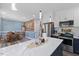 Open kitchen and dining area featuring a large island, stainless steel appliances, and wood accent wall at 5904 River Lake Cir, Raleigh, NC 27604