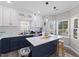 Beautiful kitchen island with white countertop, pendant lighting, white backsplash, and dark blue cabinetry at 5904 River Lake Cir, Raleigh, NC 27604