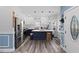 Modern kitchen featuring stainless steel appliances, a large island, white cabinets, and stylish light fixtures at 5904 River Lake Cir, Raleigh, NC 27604