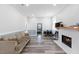 Living room with a fireplace, wood trim, wood floors, and a gray couch at 5904 River Lake Cir, Raleigh, NC 27604