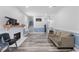 Living room with a fireplace, wood trim, wood floors, and a gray couch at 5904 River Lake Cir, Raleigh, NC 27604