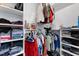 Well-organized walk-in closet featuring a variety of shelves, hanging clothes, and stored handbags at 5904 River Lake Cir, Raleigh, NC 27604