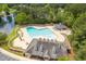 Aerial view of the pool with lounge chairs around it, a covered area and beautiful landscaping at 601 Walcott Way, Cary, NC 27519