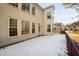 Back of home featuring an expansive snow-covered deck, windows, and a sunroom at 601 Walcott Way, Cary, NC 27519