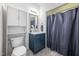 Bathroom features a blue vanity with marble countertop, and tiled floors at 601 Walcott Way, Cary, NC 27519