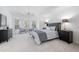 Spacious bedroom with a vaulted ceiling, sitting area, and a comfortable bed at 601 Walcott Way, Cary, NC 27519