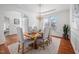 Elegant dining room with chandelier, wainscoting, and a large window at 601 Walcott Way, Cary, NC 27519