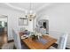 Dining room with hardwood floors, an elegant chandelier, and decorative accents at 601 Walcott Way, Cary, NC 27519