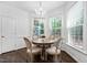 Dining room with hardwood floors, a chandelier, and windows providing natural light at 601 Walcott Way, Cary, NC 27519